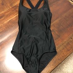 Black Nike One Piece Bathing Suit With The Nike Swoosh On Front. Crossover Straps On The Back. Protective Strip Still In Tact. Brand New Size Small Smoke Free Home Nike Black Sleeveless Swimwear, Nike One Piece, Nike One Piece Swimsuit, Nike Swimsuit, Racerback Swimsuit, High Neck Swimsuits, Nike Neon, Nike Swim, Black One Piece Swimsuit