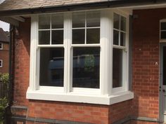 a red brick house with white double glazed windows