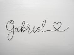 the word garberl written in cursive writing on a white wall