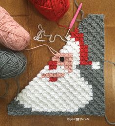 a crocheted christmas ornament next to yarn and balls of knitting needles