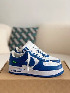 Embrace iconic style with these statement-making sneakers inspired by the legendary Louis Vuitton x Nike Air Force 1 collaboration. The vibrant blue leather upper, accented with the signature Louis Vuitton monogram, exudes luxury and street-style cool. Off-White™-inspired details add a contemporary edge, like the quoted "AIR" branding and exposed stitching. Step into the spotlight with these coveted kicks that blend high-fashion and sneaker culture. Your order arrives in a branded shoe box, comp Blue Sporty High-top Sneakers With Logo, Blue Logo Sneakers For Streetwear, Blue Lace-up Sneakers With Logo, Modern High-top Custom Sneakers With Logo Print, Blue Leather Sneakers With Logo, Blue Sporty Sneakers With Logo, Blue Sports Sneakers With Logo, Casual Blue High-top Sneakers With Logo, Designer Logo Sneakers For Streetwear