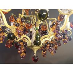 a chandelier with many different colored beads hanging from it's centerpiece