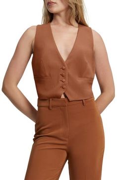 This cropped V-neck vest layers for work and wears alone for dinner. V-neck Lined 100% polyester Hand wash, line dry Imported Elegant V-neck Crop Top For Workwear, Elegant V-neck Crop Top For Work, Chic Cropped Tank Top, Brown V-neck Vest For Workwear, Brown V-neck Vest For Work, Brown Summer Workwear Vest, Fitted Brown V-neck Crop Top, Elegant Tank Top For Fall, Chic Spring Crop Top Vest