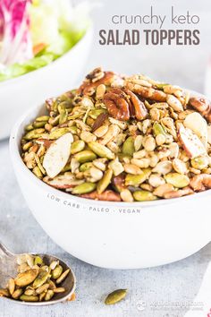 a white bowl filled with salad topped with nuts