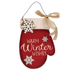 a christmas ornament hanging from the side of a red mitt with snowflakes on it