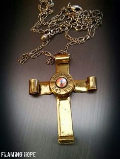 a cross that is sitting on top of a metal surface with the words flaming hope