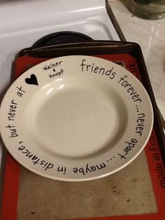 a white plate sitting on top of a red and black tray next to a cup