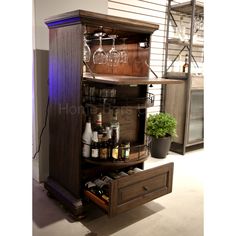 a cabinet with wine glasses and bottles in it