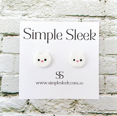 a pair of white cat ear studs sitting on top of a sign