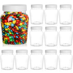 a jar filled with lots of different colored candies next to each other on a white background