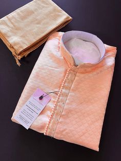 PLEASE NOTE - The Kurta does NOT come with Lining.  Designer Light Pastel Peach Kurta Self Embroidery. The neckline has beautiful  handwork done.  Very trendy and Classy Looking Mens Wear. Item : Men's Kurta Pajama Ready to Wear : Yes Kurta Color : Pastel Light Peach Color  Pajama Color : Gold Brown  Fabric :  Soft Silk  Pocket : Yes Work :  Fancy Buttons Lining : No  Disclaimer -For sizing please refer to the Size Chart given in the listing with the pictures. - Please do NOT go by the size of t Peach Embroidered Kurta For Wedding, Orange Zari Work Sherwani For Wedding, Peach Wedding Traditional Wear With Chikankari Embroidery, Orange Sherwani With Zari Work For Wedding, Orange Wedding Sherwani With Zari Work, Wedding Orange Sherwani With Zari Work, Cotton Kurta With Zari Work For Wedding, Festive Chikankari Embroidery Kurta For Ceremony, Festive Ceremony Kurta With Chikankari Embroidery