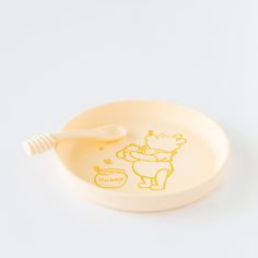 a bowl with a spoon in it that has a drawing on the side of it