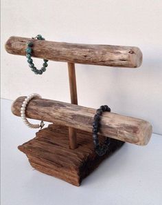 a wooden stand with bracelets and beads on it