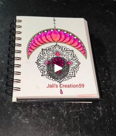 a spiral notebook with the title jalis creations 59 on it and an image of a flower