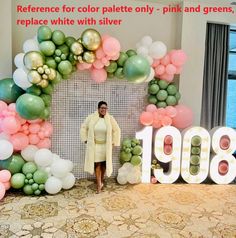 a man standing in front of a backdrop made out of balloons and letters that read, reference for color palette only - pink and greens, replace white with silver