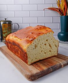 a loaf of bread sitting on top of a wooden cutting board