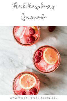 two glasses filled with fresh raspberry lemonade on top of a marble counter