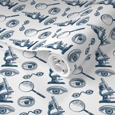 a white and blue wallpaper with eyeballs, microscopes, and glasses on it