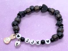 "Adorable Koocore bracelet inspired by Jungkook's aesthetic 🖤 Comes with freebies <3 ✨Choose your charms! All charms are nickel-free and lead-free. Bunny charm is enamel with gold-tone backs and padlock charms are silver-tone and double sided.  ✨Made with elastic stretch cord with knots glued for security ✨Bracelet circumference is 6.75\" unless you request a resizing in the personalization box or order note (please see FAQ for more info on sizing) 🦋Disclaimers 🦋 -If you get a sizing adjustme Handmade Black Kpop Beaded Bracelets, Handmade Black Beaded Kpop Bracelet, Trendy Black Heart Beaded Bracelets, Trendy Black Heart-shaped Beaded Bracelets, Personalized Black Kpop Jewelry, Black Personalized Kpop Jewelry, Personalized Black Kpop Style Jewelry, Kpop Black Jewelry With Letter Beads, Black Kpop Style Jewelry With Letter Beads