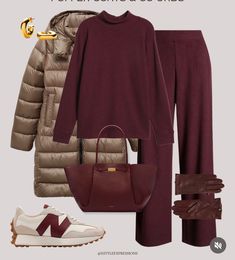 a woman wearing burgundy pants and a maroon sweater is shown in the image with her handbag