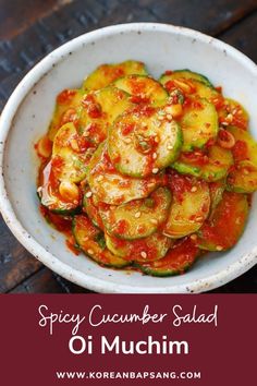 spicy cucumber salad in a white bowl on a wooden table with text overlay