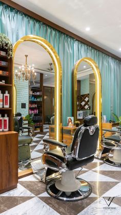 the salon has many chairs in it and is decorated with gold trimmings on the walls