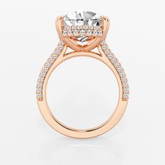 a rose gold engagement ring with an oval center stone and pave set diamonds around the band