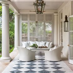 an outdoor living room with white furniture and checkered flooring