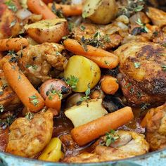 a bowl filled with meat, potatoes and carrots