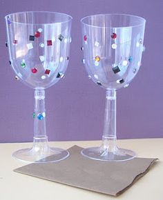 two clear wine glasses sitting on top of a table