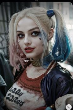 a woman with blue hair and makeup is dressed as harley harley from the dark knight movie