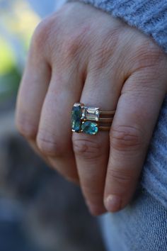 This waterfall of color is simple, classic and bold. You will be intrigued by all that it can do. Stack it with other colorful rings or wear it alone. Deco in feel, but super modern in taste. This 14k recycled gold stacking stone ring features a baguette cut blue tourmaline set in two-sided bezel. Pictured in:14k yellow gold1.26ct blue green tourmaline2mm wide Jennifer Dawes Design works with responsible diamantaires. Due to fluctuations in the diamond market, pricing varies on diamonds based on Modern 14k Gold Emerald Cut Birthstone Ring, Modern Multi-stone Emerald Cut Jewelry, Emerald Cut Gemstone Stackable Rings In 14k Gold, Modern 14k Gold Emerald Ring, Modern Multi-stone Rings, Modern 14k Gold Multi-stone Jewelry, Modern Multi-stone Birthstone Ring, Modern 14k Gold Open Emerald Ring, 14k White Gold Stackable Emerald Cut Rings