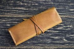 a brown leather case sitting on top of a wooden table