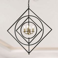 a chandelier with three lights hanging from it's center and an intricate design