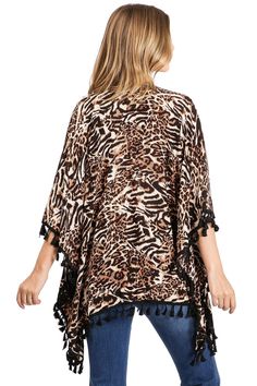 Kimono cardigan with a bold tiger print, 3/4 sleeves with a tassel trim along the edges. Effortless silhouette, perfect for layering over casual outfits or over a swimsuits. CARE | Hand Wash Cold CONTENTS | 100% Viscose MEASUREMENTS | 26"/66 cm Top to Bottom (Size O/S) MODEL | 5'8 - wearing O/S IMPORTED Vacation Long Sleeve Tassel Cover-up, Long Sleeve Fringe Cover-up For Spring, Spring Long Sleeve Fringe Cover-up, Long Sleeve Fringe Beach Cover-up, Spring Open Front Cover-up With Tassels, Long Sleeve Fringe Cover-up For Vacation, Long Sleeve Fringe Summer Cover-up, Long Sleeve Fringe Top For Vacation, Trendy Beach Top With 3/4 Sleeves