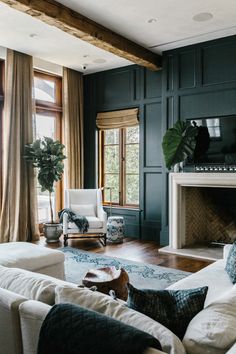 a living room filled with furniture and a fire place in the middle of a room