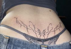 a woman's stomach with tattoos on it