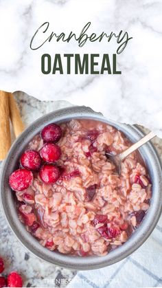 cranberry oatmeal in a bowl with berries and cinnamon on the side