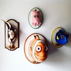 three plates with cartoon characters on them hanging from the wall