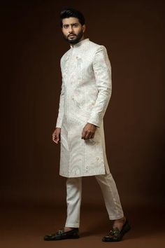 Ivory sherwani with mandarin collar, full sleeves, all over vintage pattern ekhtar resham embroidery and sequin work. Paired with silk kurta and cotton pyjama.
Components: 3
Pattern: Embroidered
Type Of Work: Ekhtar Resham and Sequin Work
Neckline: Mandarin Collar
Sleeve Type: Full Sleeves
Fabric: Sherwani: heavy Modal, Kurta: Silk, Pyjama: Cotton
Color: Beige
Other Details: 
Front concealed placket
Back placement embroidery
Front and side slits
Occasion: Groom,Wedding - Aza Fashions Ivory Sherwani, Embroidered Sherwani, Placement Embroidery, Sherwani Groom, Resham Embroidery, Wedding Sherwani, Silk Kurta, Suit Pant, Nehru Jackets