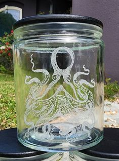 a glass jar with an octopus etched on it