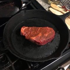 a steak is cooking in a skillet on the stove