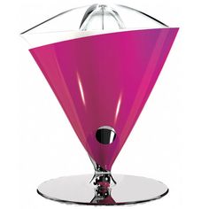 a pink glass vase sitting on top of a white plate next to a black object