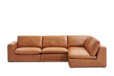 a tan leather sectional sofa with chaise lounger on the bottom and back end