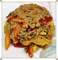 a white plate topped with rice and veggies covered in seasoning next to a leaf