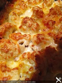 a cheesy casserole dish with meatballs and cheese on the top