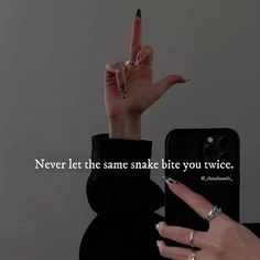 a woman's hand holding up a cell phone with the words never let the same snake bite you twice