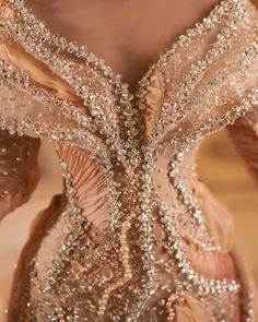 the back of a woman's dress with sequins and beads on it