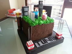 a cake made to look like an office cubicle with legos and cars on it