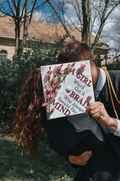 a woman holding up a sign with the words a girl has a brain behind her head